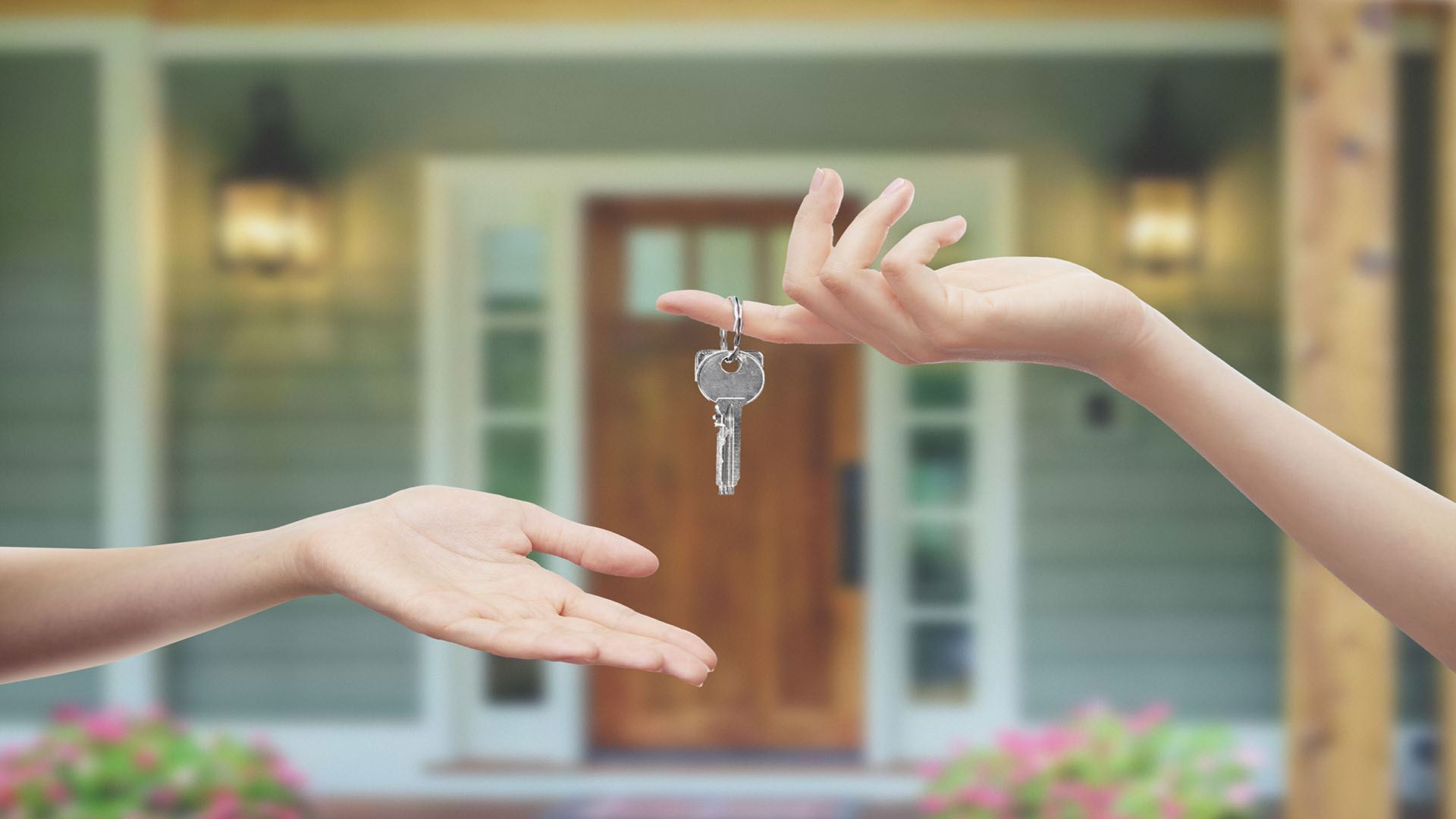 person handing keys to someone else
