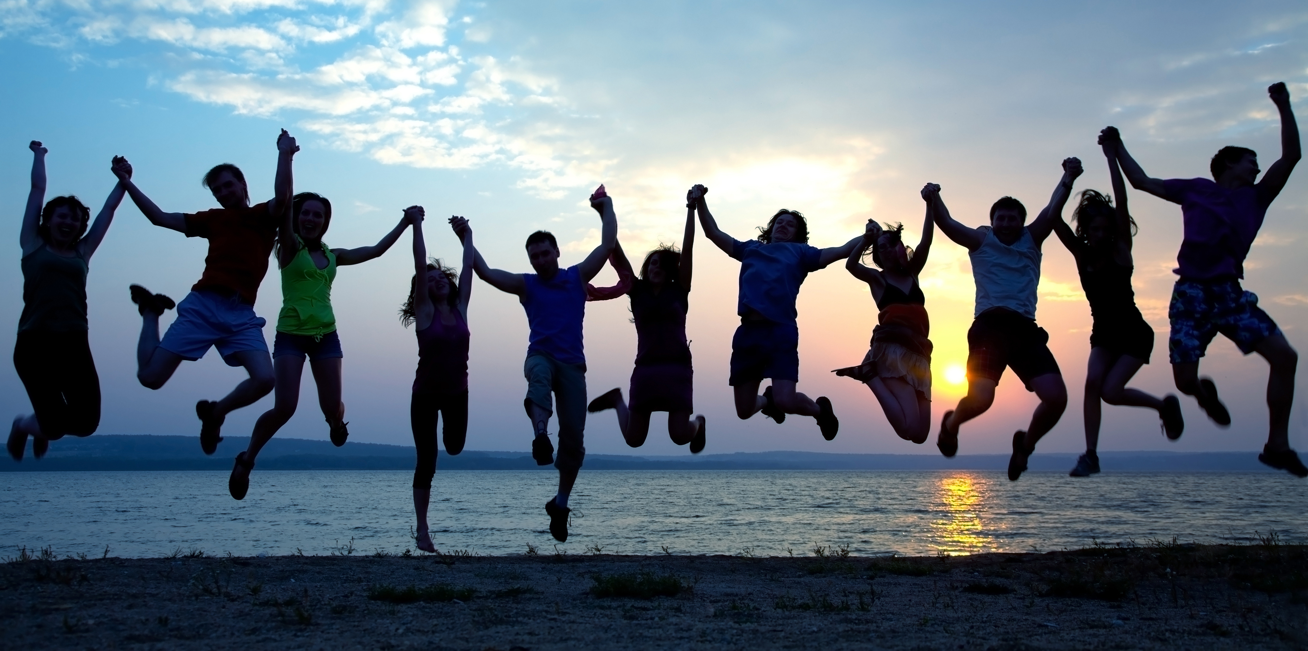 people holding hands and jumping