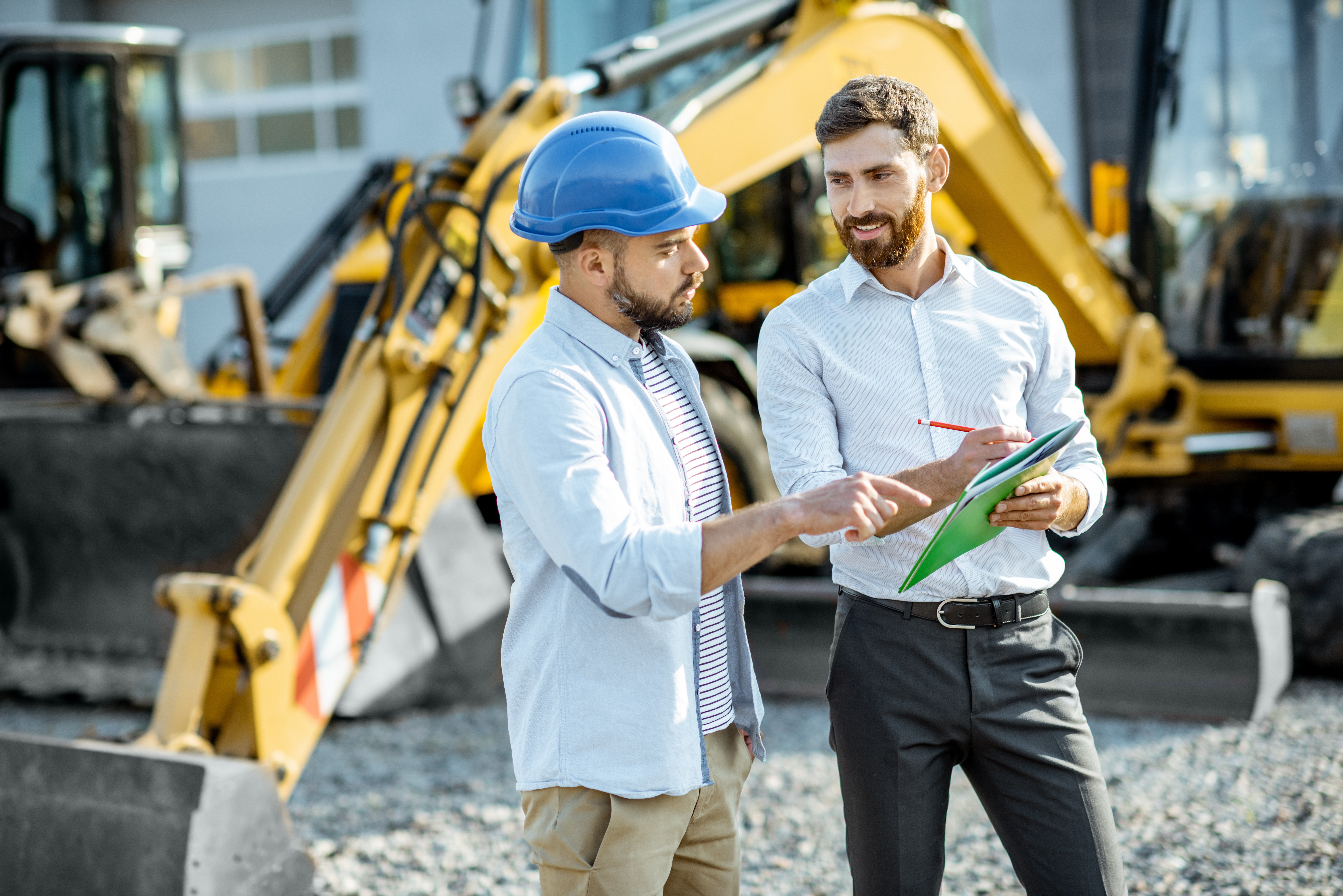 2 men with heavy equipment