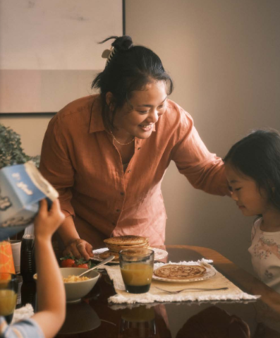 woman and children eating breakfast